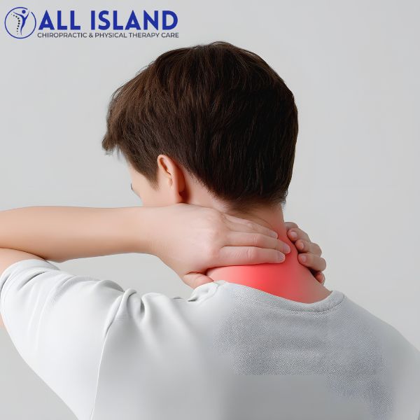 Neck Pain Treatment Person holding the back of their neck in apparent pain, with a red area indicating discomfort, under the All Island Chiropractic & Physical Therapy Care logo
