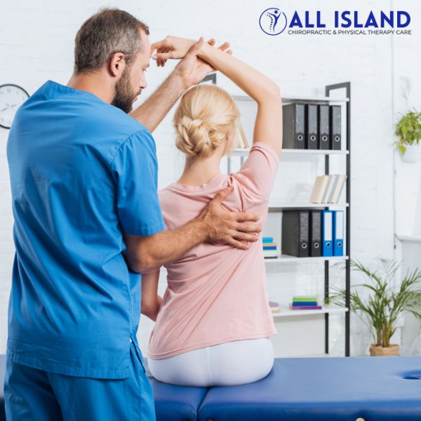 no-fault injury treatment (1) A physical therapist assists a woman with a shoulder stretch in a medical office The "All Island Chiropractic & Physical Therapy Care" logo is visible in the top right corner, highlighting your trusted No Fault Doctor near Islip