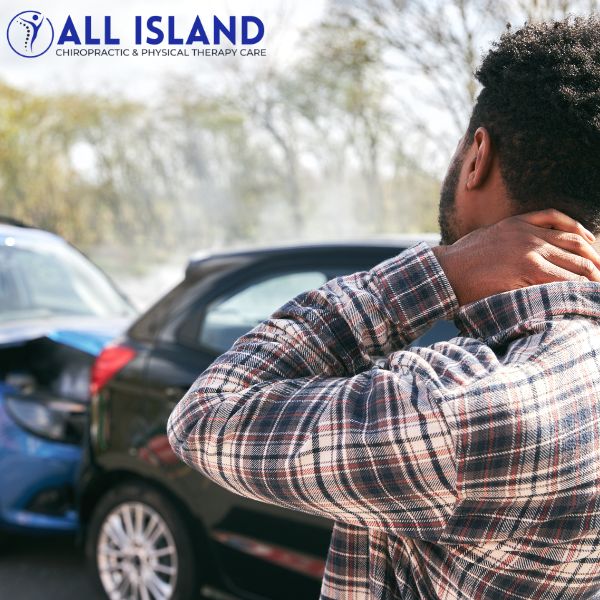 no-fault injury treatment A man holding his neck stands near two cars involved in a rear end collision, with the All Island Chiropractic & Physical Therapy Care logo and "No Fault Doctor near Islip" visible in the corner