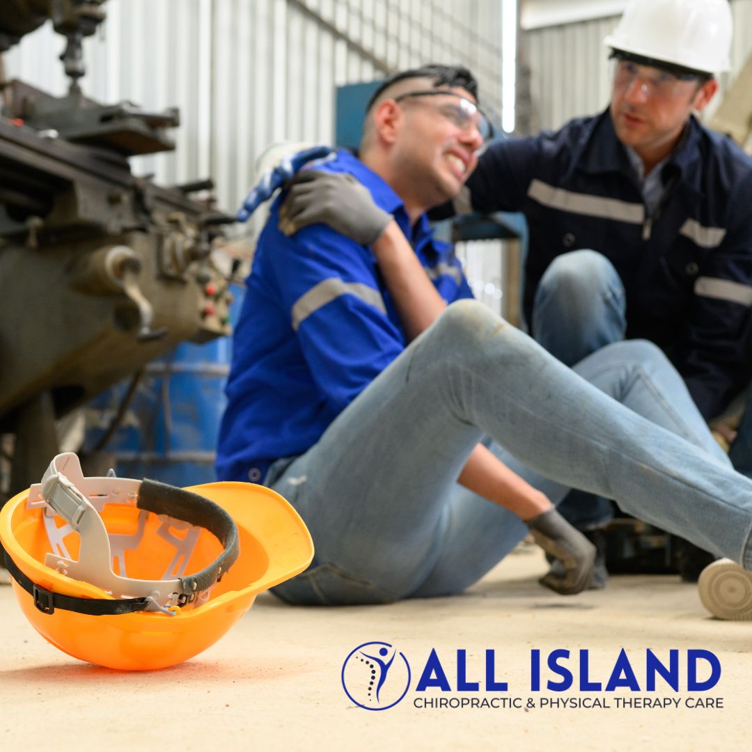 All island Chiro - Chiropractor in Bay Shore NY (2) A worker sits on the floor holding his shoulder in pain while a colleague assists; a safety helmet lies nearby The All Island Chiropractic & Physical Therapy Care logo is visible, suggesting the need for a workers comp doctor in Wading River